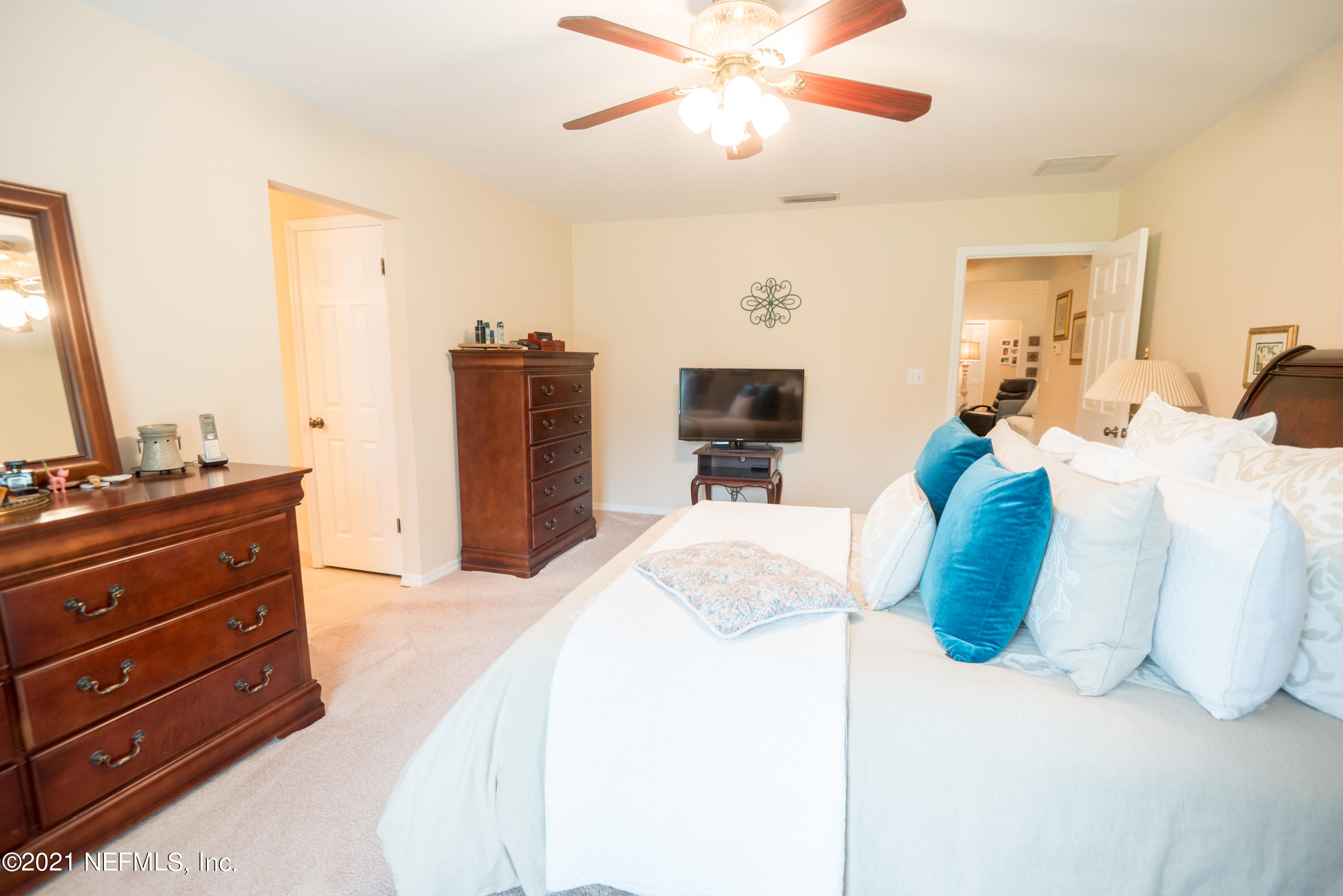 5200 Northwest 180th Way Starke, FL 32091 - Photo 34 of 83 a bedroom with a bed and a chandelier
