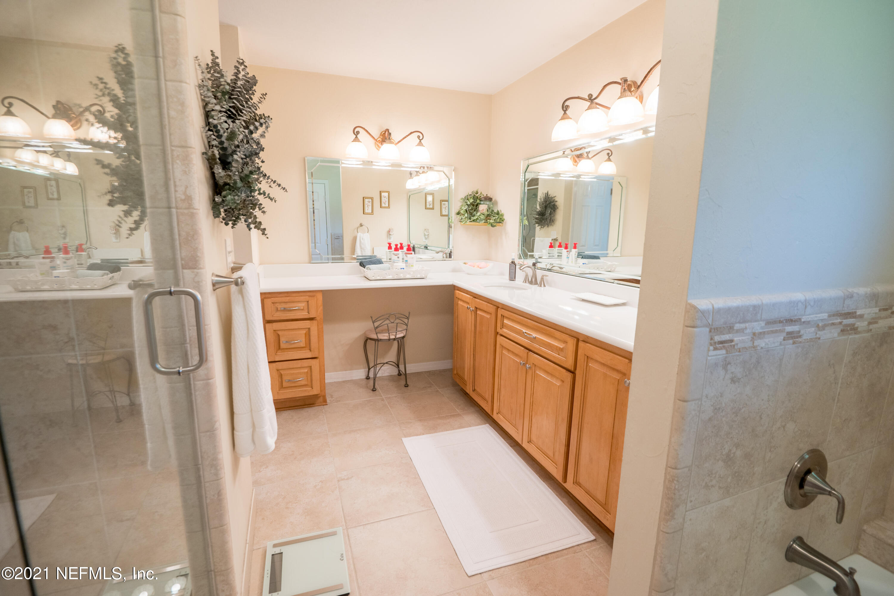 5200 Northwest 180th Way Starke, FL 32091 - Photo 41 of 83 a large bathroom with a double vanity sink a mirror and a bathtub