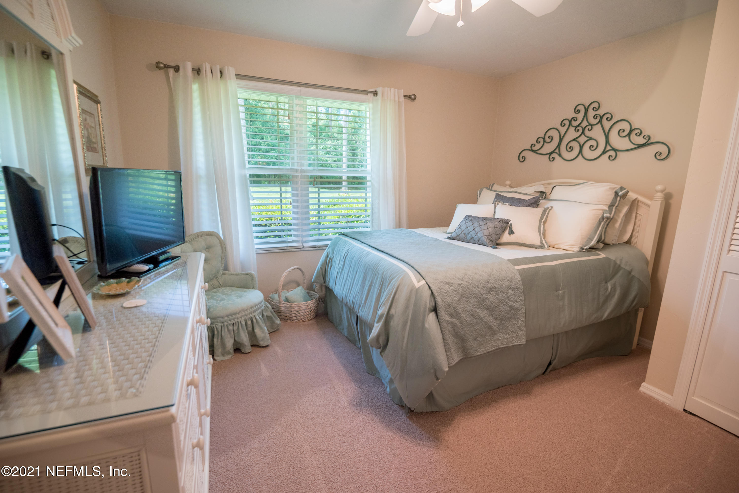 5200 Northwest 180th Way Starke, FL 32091 - Photo 48 of 83 a bedroom with a bed and a flat tv screen on dresser