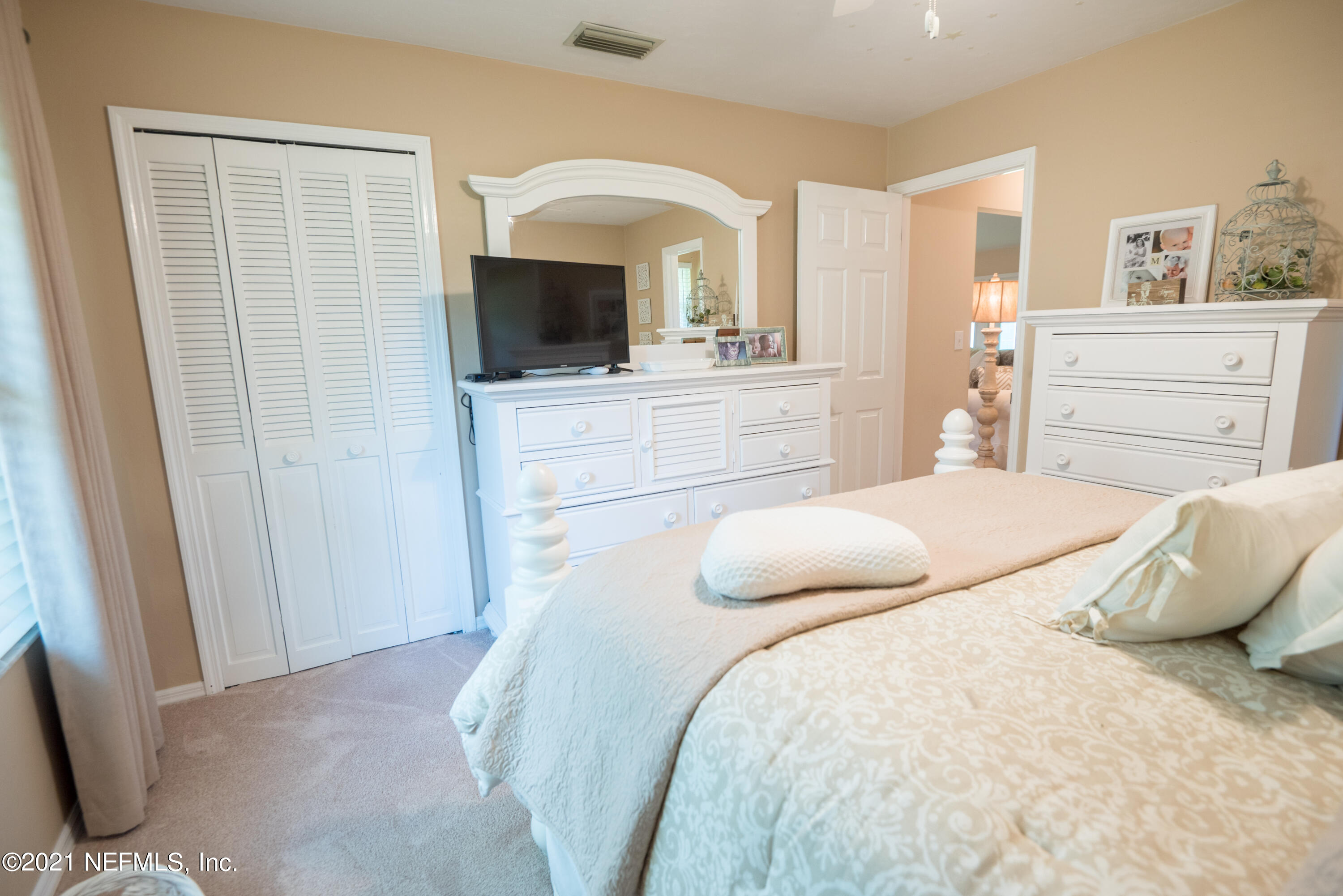 5200 Northwest 180th Way Starke, FL 32091 - Photo 63 of 83 a bedroom with a large bed and flat tv screen