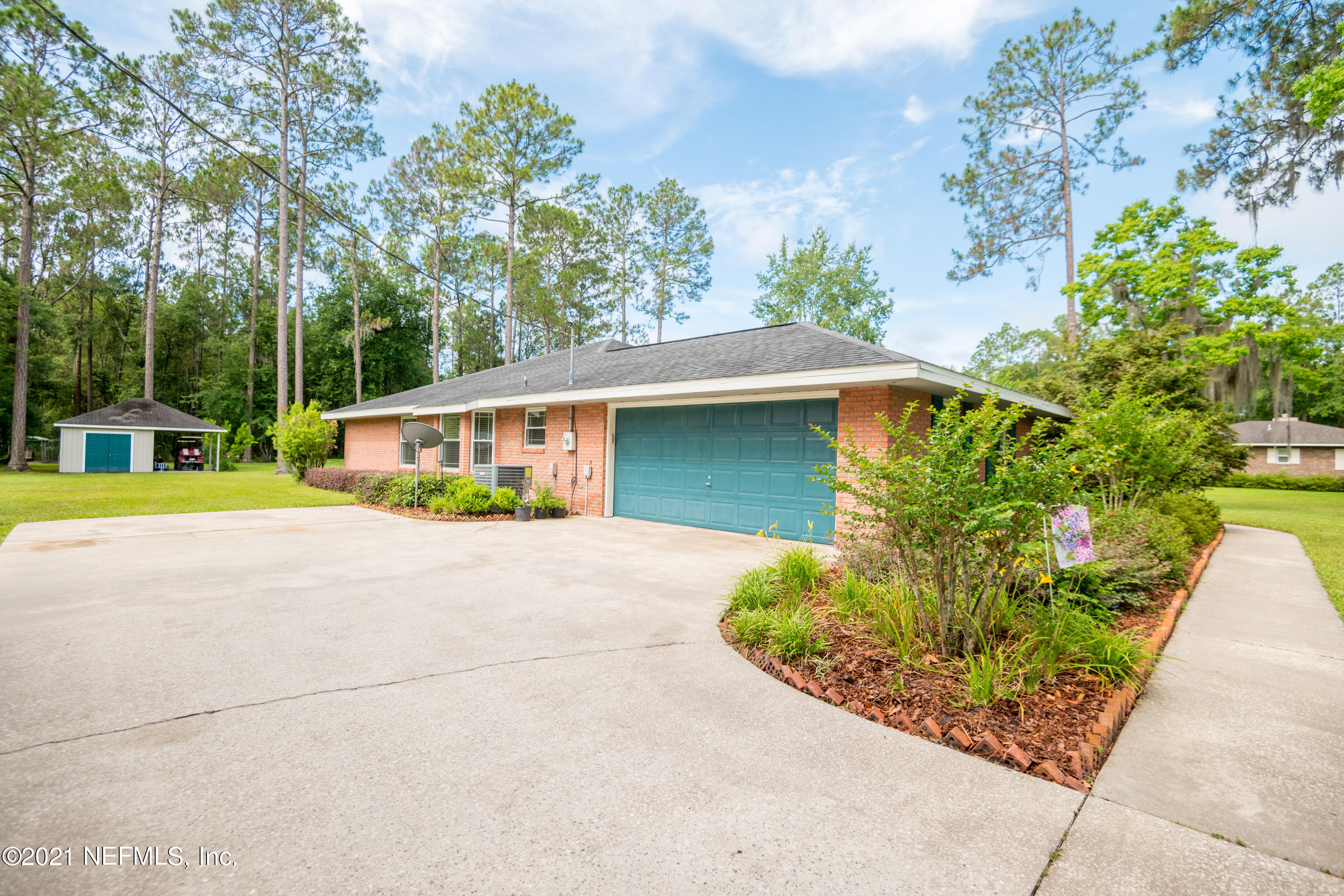 5200 Northwest 180th Way Starke, FL 32091 - Photo 71 of 83 front view of a house with a yard and potted plants