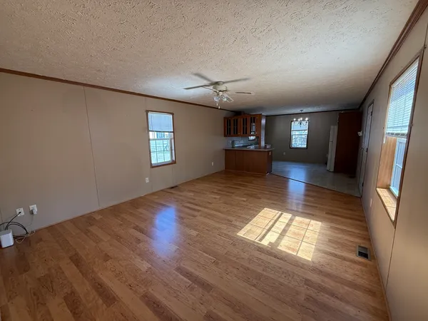 wooden floor in an empty room with windows