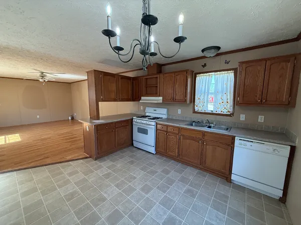 a kitchen with cabinets a sink and appliances