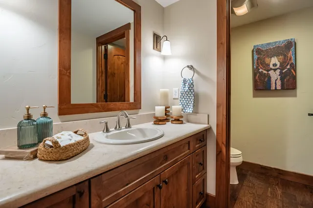 a bathroom with a granite countertop sink and a mirror