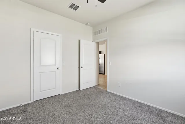 an empty room with a empty space and a ceiling fan