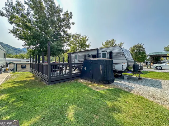 a view of a house with a yard and sitting area
