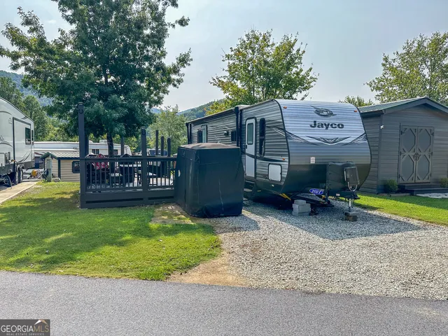 a view of a house with backyard porch and sitting area