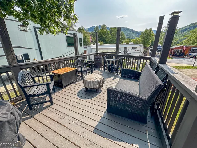 a balcony with wooden floor outdoor seating and wooden floor