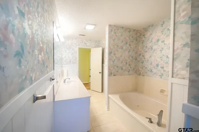 a bathroom with a tub a sink and a shower curtain