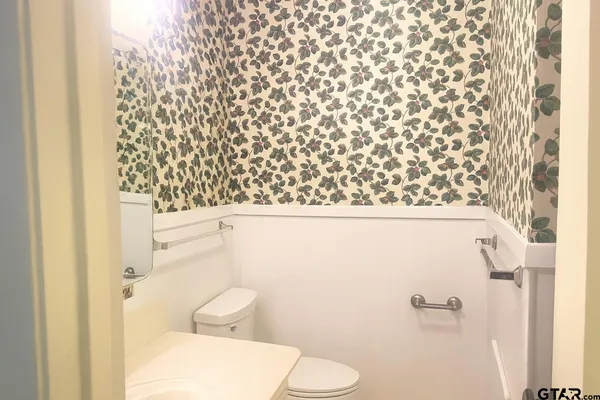 a bathroom with a toilet and a shower curtain