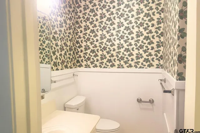 a bathroom with a toilet and a shower curtain