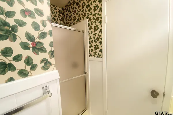 a bathroom with a shower curtain and a sink