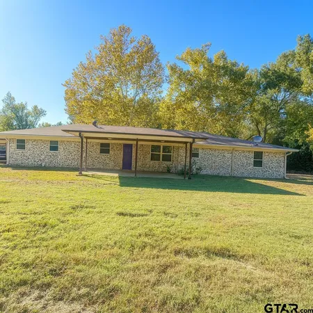 a house view with swimming pool in front of it