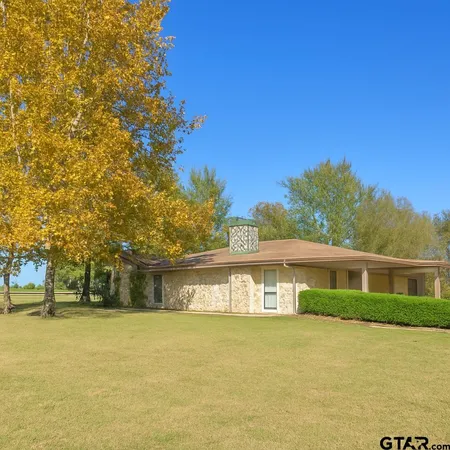 a front view of a house with a lake