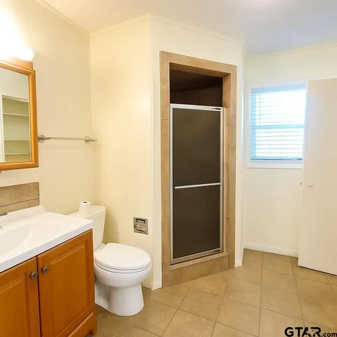 a bathroom with a toilet a sink and shower