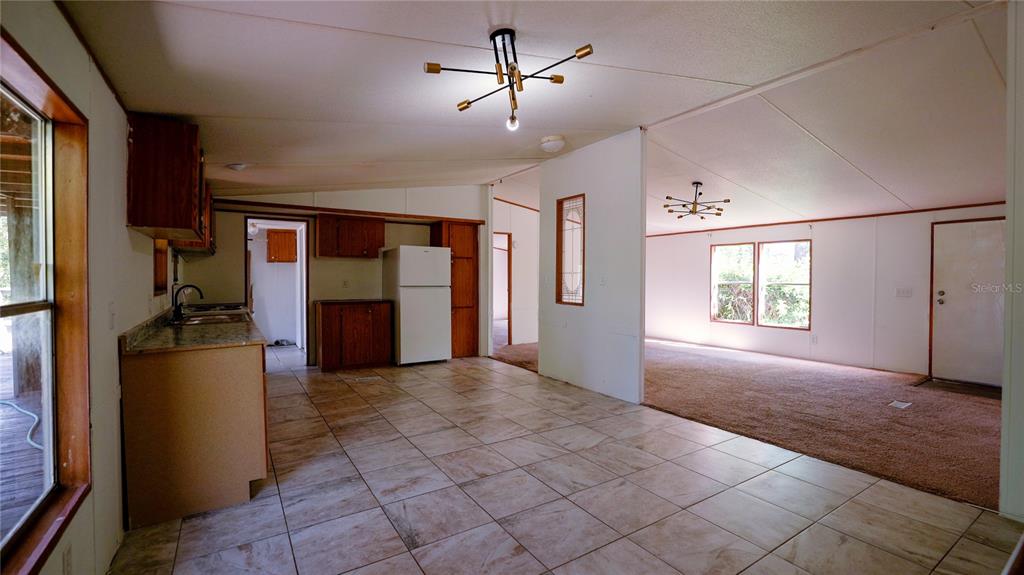 1550 East Orlando Road Orlando, FL 32820 - Photo 12 of 27 a view of livingroom with hardwood floor and a ceiling fan