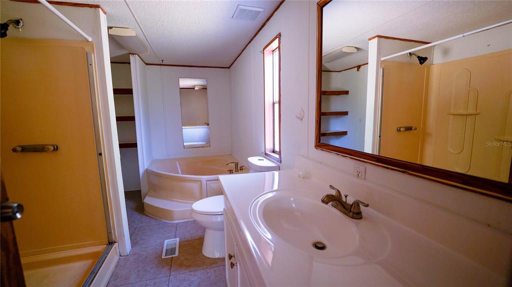 1550 East Orlando Road Orlando, FL 32820 - Photo 15 of 27 a bathroom with a sink and a mirror