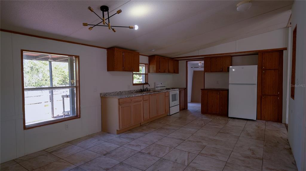 1550 East Orlando Road Orlando, FL 32820 - Photo 20 of 27 a kitchen with stainless steel appliances granite countertop a refrigerator and a sink