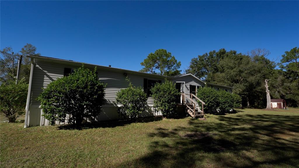 1550 East Orlando Road Orlando, FL 32820 - Photo 2 of 27 a view of a house with a backyard