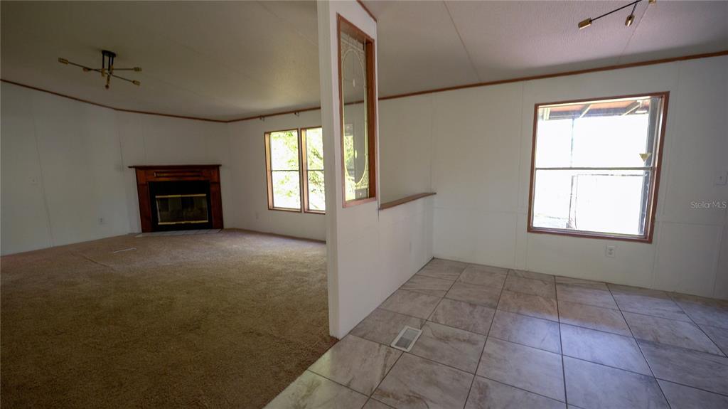 1550 East Orlando Road Orlando, FL 32820 - Photo 22 of 27 an empty room with windows and fireplace