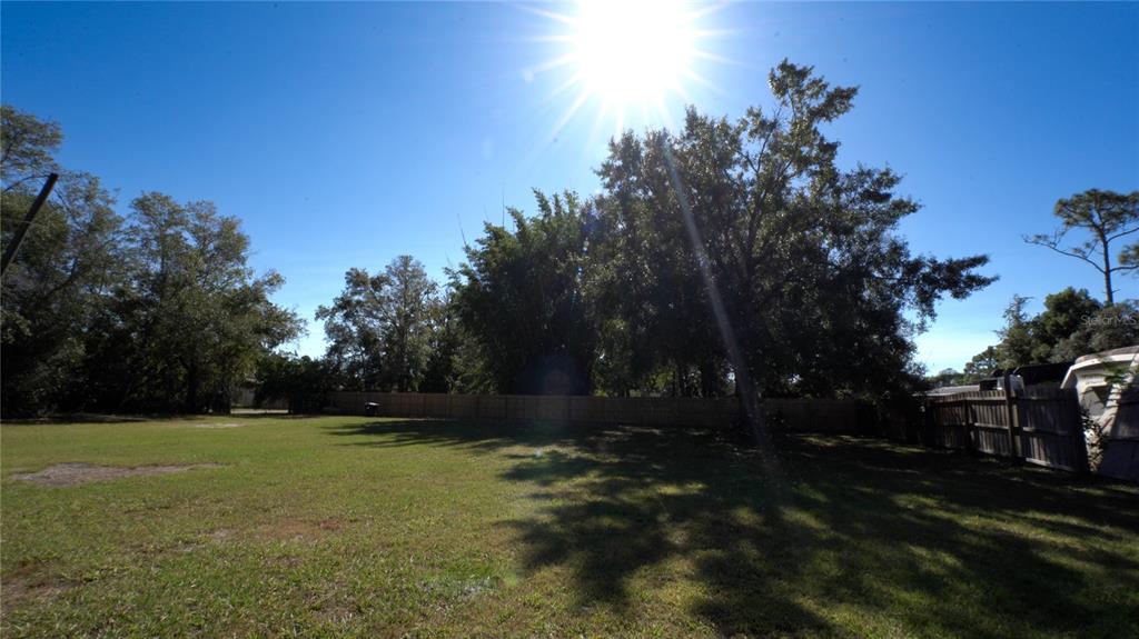 1550 East Orlando Road Orlando, FL 32820 - Photo 26 of 27 a view of outdoor space with deck and yard