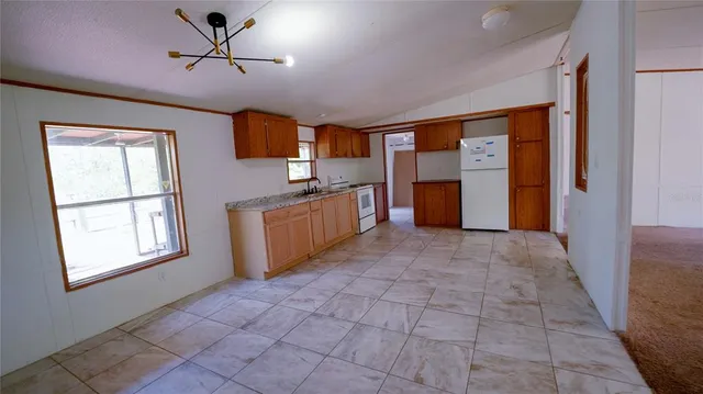 a view of a kitchen with a sink and cabinets