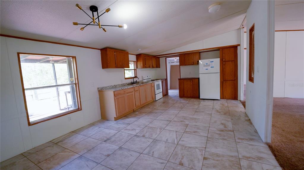 1550 East Orlando Road Orlando, FL 32820 - Photo 4 of 27 a view of a kitchen with a sink and cabinets