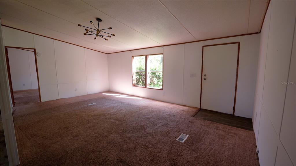 1550 East Orlando Road Orlando, FL 32820 - Photo 5 of 27 an empty room with windows and fan