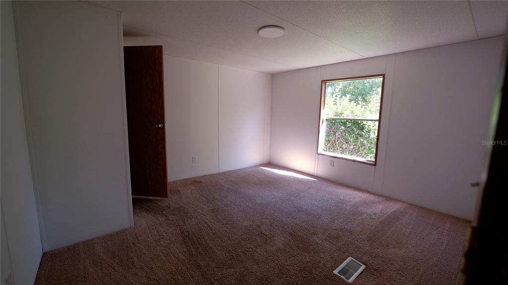 1550 East Orlando Road Orlando, FL 32820 - Photo 6 of 27 an empty room with windows