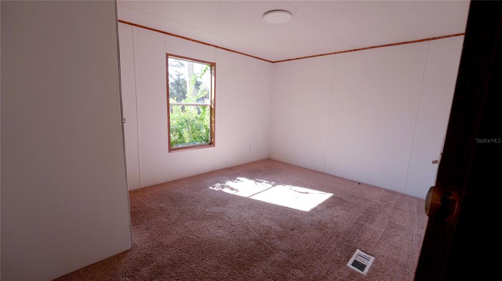 1550 East Orlando Road Orlando, FL 32820 - Photo 8 of 27 a view of an empty room with a window