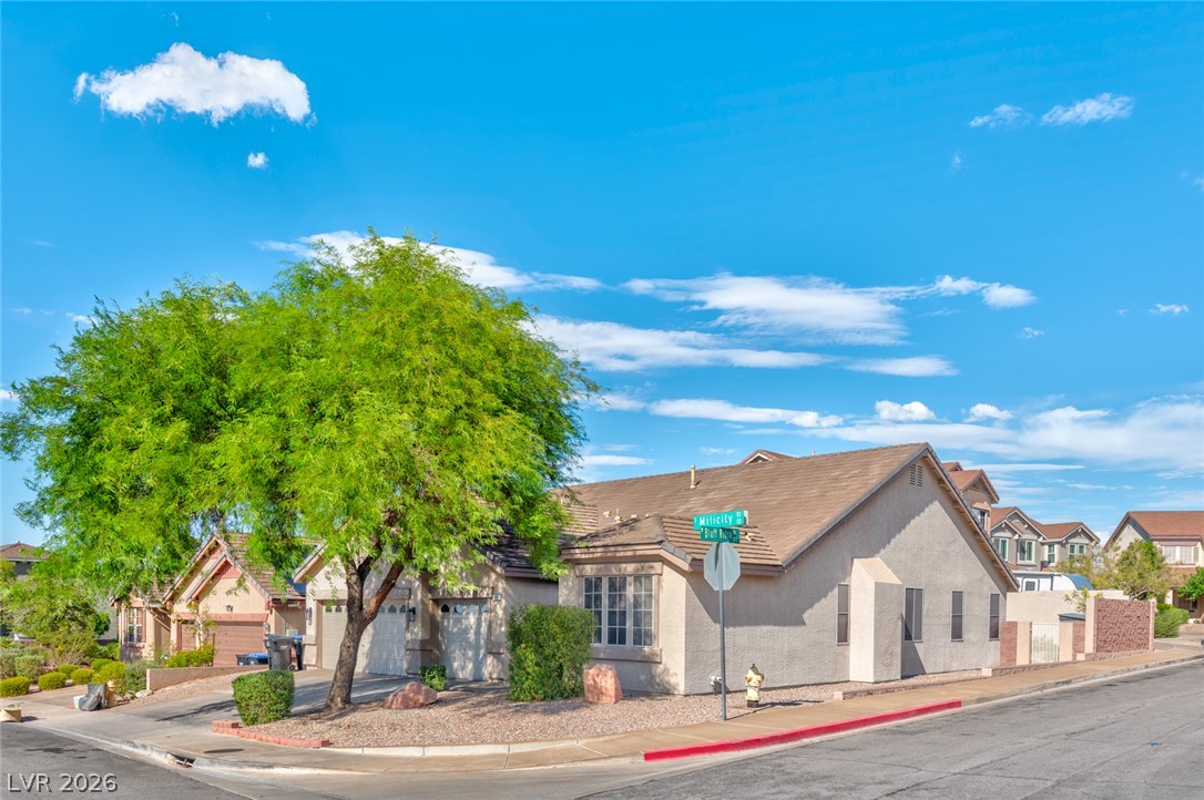 84 Milicity Road Henderson, NV 89012 - Photo 16 of 16 A classic stucco exterior with tile roofing anchors this corner lot home.