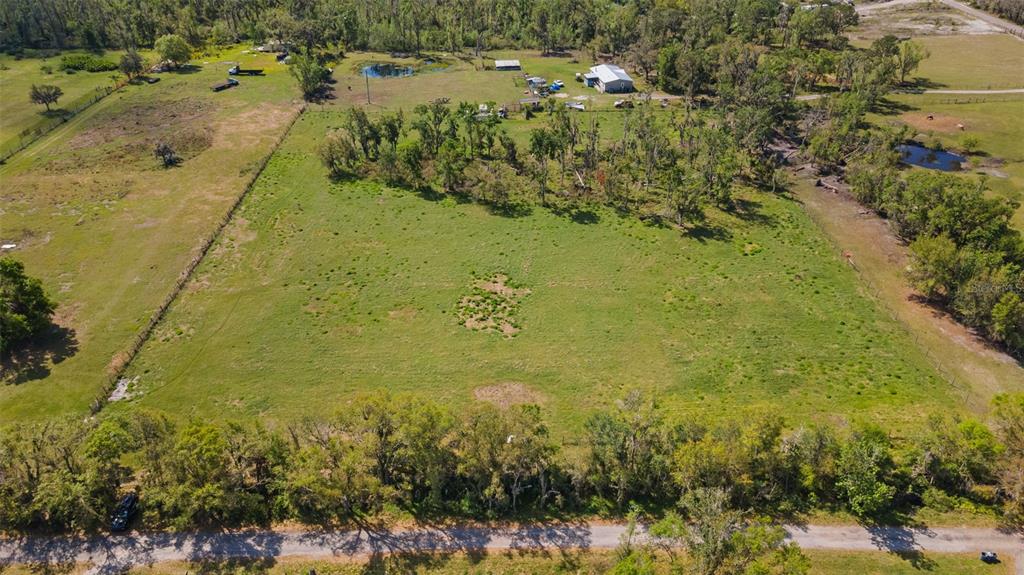 11041 Revell Road Parrish, FL 34219 - Photo 10 of 11 a view of a lake with large trees