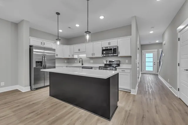 a kitchen with appliances cabinets and a sink