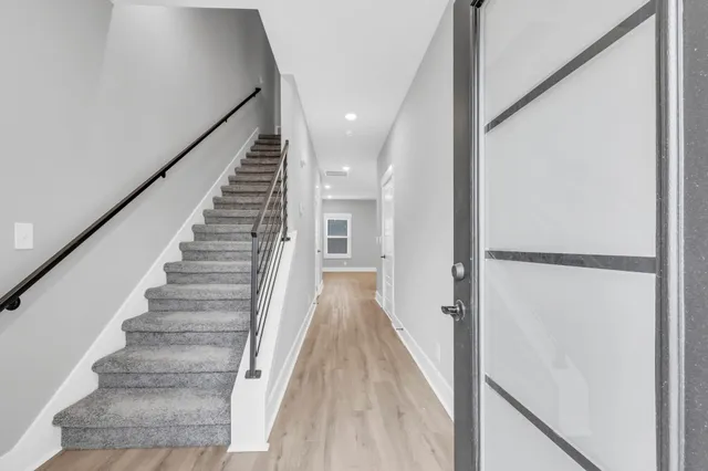 a large kitchen with stainless steel appliances kitchen island a cabinets and wooden floor