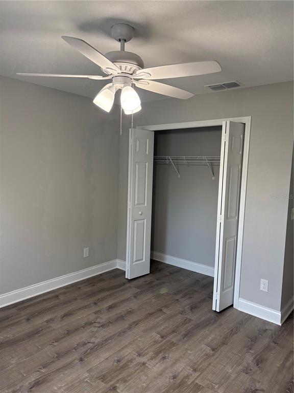 526 2nd Street Southwest Fort Meade, FL 33841 - Photo 4 of 21 an empty room with wooden floor fan and windows