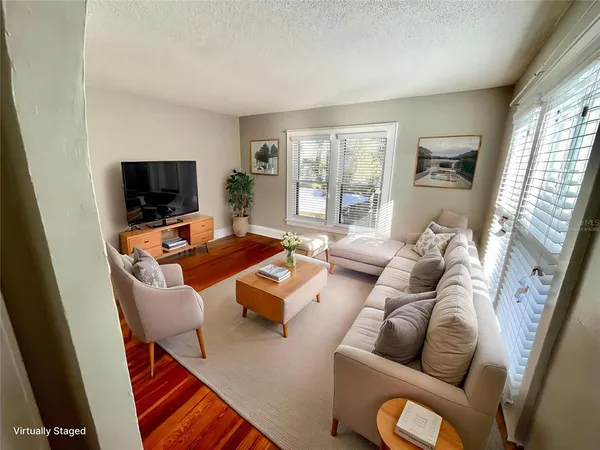 a view of a room with wooden floor