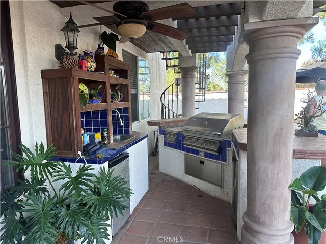 a kitchen with stainless steel appliances granite countertop a stove a window and a potted plant