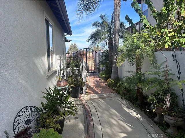 a view of a house with a yard fire pit and palm tree