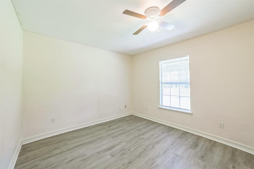 2861 Fm 727 Jefferson, TX 75657 - Photo 18 of 35 an empty room with wooden floor and fan