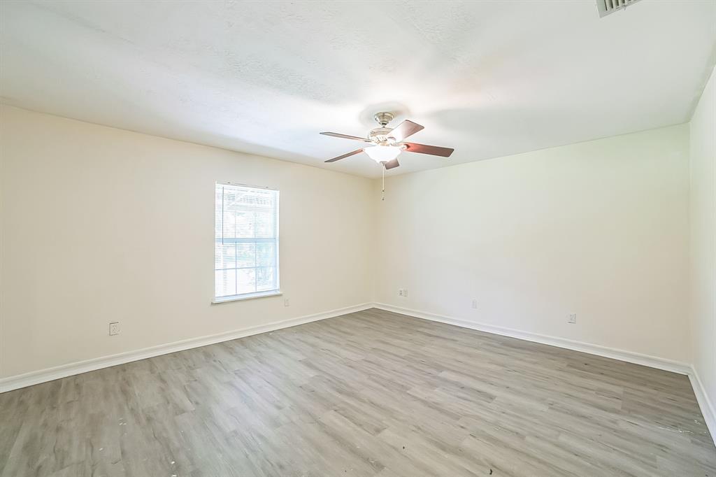 2861 Fm 727 Jefferson, TX 75657 - Photo 23 of 35 wooden floor in an empty room with a window