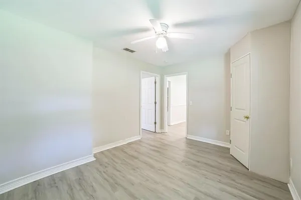 a view of an empty room with wooden floor