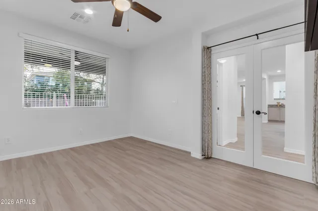 a bedroom with two beds and a large window