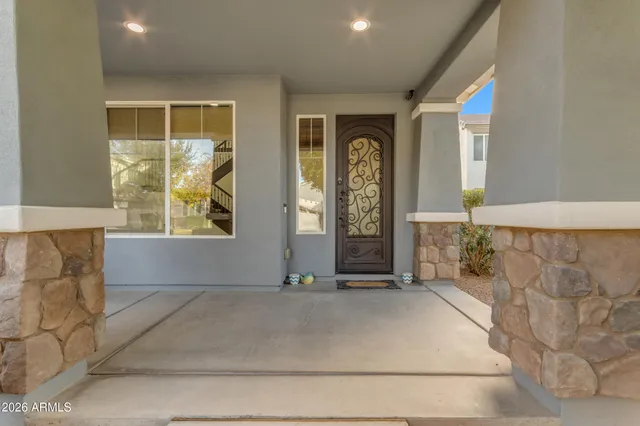 a kitchen with stainless steel appliances kitchen island a table and chairs in it