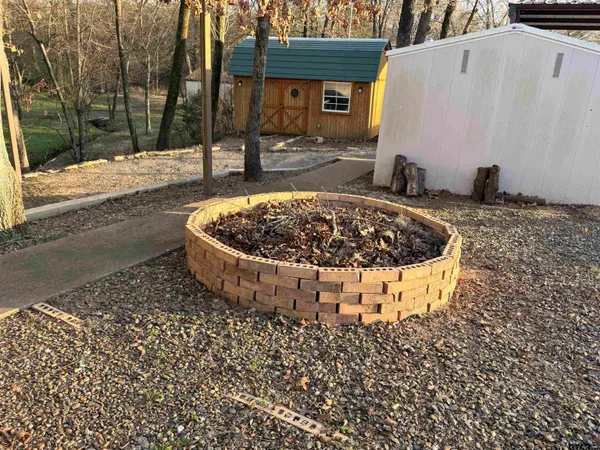 a bedroom with a bed and a large mirror with window