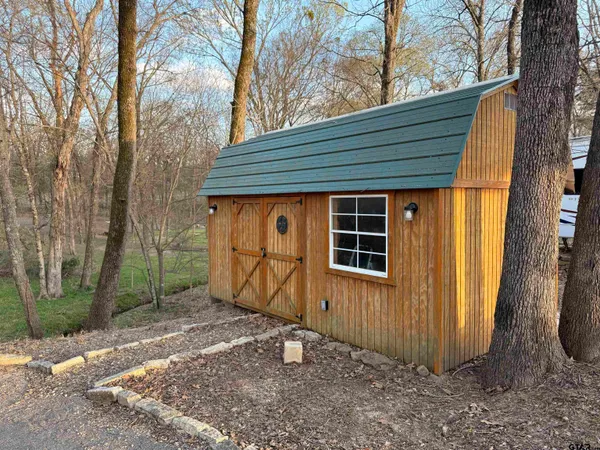 a bathroom with a sink a mirror and a shower