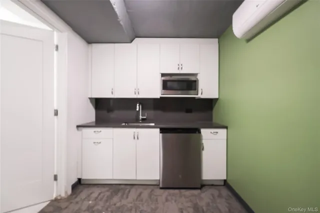a kitchen with stainless steel appliances a sink and a microwave