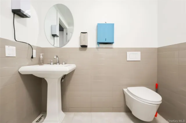 a bathroom with a sink toilet and mirror
