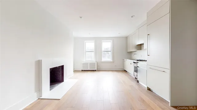 a kitchen with stainless steel appliances a stove top oven and a refrigerator