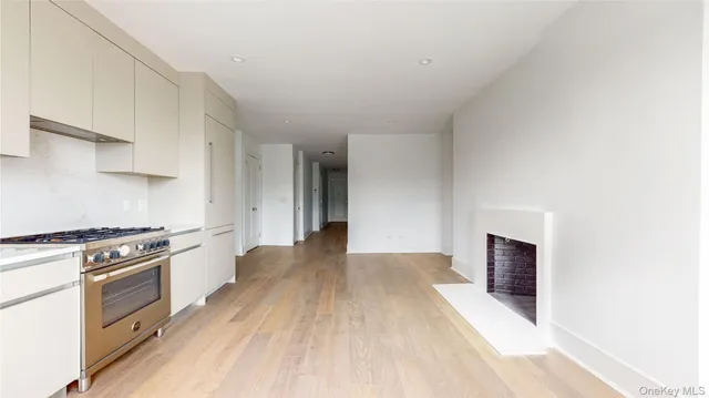 a kitchen with stainless steel appliances a stove top oven and cabinets