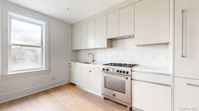 a kitchen with granite countertop white cabinets and white appliances